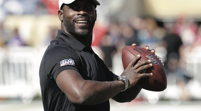 Former NFL quarterback Michael Vick smiles while warming up before the NFL Pro Bowl in January 2020, in Orlando, Fla.