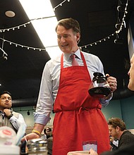 Gov. Glenn Youngkin serves coffee to patrons at McLean’s Restaurant Dec. 16
after announcing a “no-tax-on-tips” budget proposal.
