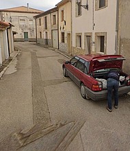 A Google Maps image showing a man leaning over the trunk of a car in Tajueco, Spain.
Mandatory Credit:	Google Maps via CNN Newsource