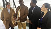 Artis Whitehead, second from left, speaks with reporters about a lawsuit filed against the city of Memphis and 10 police officers over his wrongful conviction in the 2002 robbery of a music club on Monday, Dec. 16, in Memphis, Tenn.