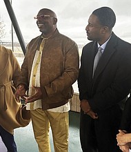 Artis Whitehead, second from left, speaks with reporters about a lawsuit filed against the city of Memphis and 10 police officers over his wrongful conviction in the 2002 robbery of a music club on Monday, Dec. 16, in Memphis, Tenn.