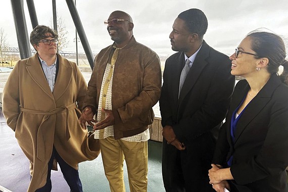 Artis Whitehead, second from left, speaks with reporters about a lawsuit filed against the city of Memphis and 10 police officers over his wrongful conviction in the 2002 robbery of a music club on Monday, Dec. 16, in Memphis, Tenn.