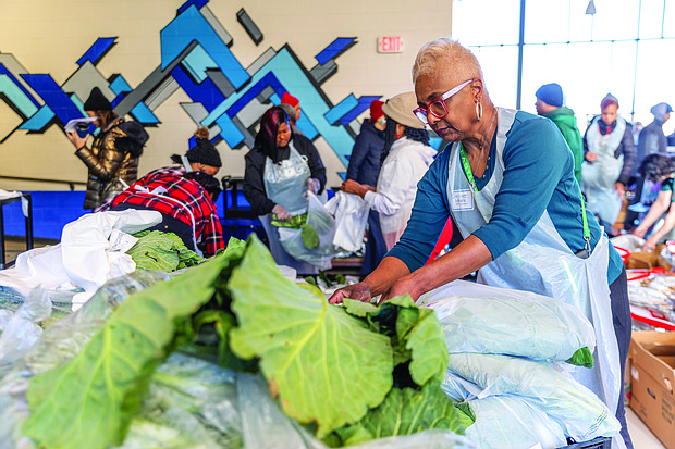 Denise Lewis, of the Richmond Chapter of The Links, volunteers at the Holiday Harvest
Food Distribution event on Dec. 21 at Martin Luther King Jr. Middle School. The event,
which distributed food to local families, was hosted by Richmond Public Schools in
collaboration with Feed More and Lulus Local Food.