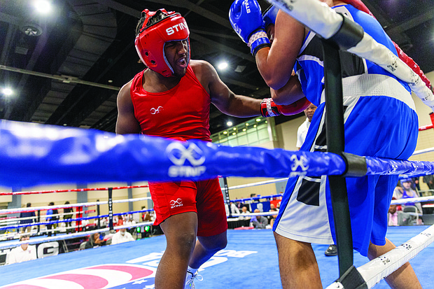 Nnajai Wright, a senior at Thomas Jefferson High School, takes on Carlos Muniz at the USA Boxing National Championships, held at the Greater Richmond Convention Center on Saturday.