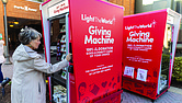 Susan Lee uses the reverse vending machine, which opened for donations on Dec. 20.
Richmond is one of 106 cities worldwide hosting a Light the World Giving Machine this
Christmas season, marking the second year of participation.