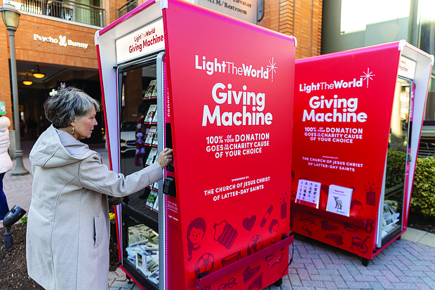 Susan Lee uses the reverse vending machine, which opened for donations on Dec. 20.
Richmond is one of 106 cities worldwide hosting a Light the World Giving Machine this
Christmas season, marking the second year of participation.