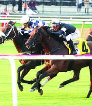 Jockey Jose Ortiz rides thoroughbred Moira to a close victory at Colonial Downs’ Festival of Racing in August. Racing season returns on March 13.