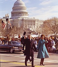 The Carters surprise onlookers, leaving their car and walking down Pennsylvania Avenue during the Inaugural Parade on Jan. 20, 1977.