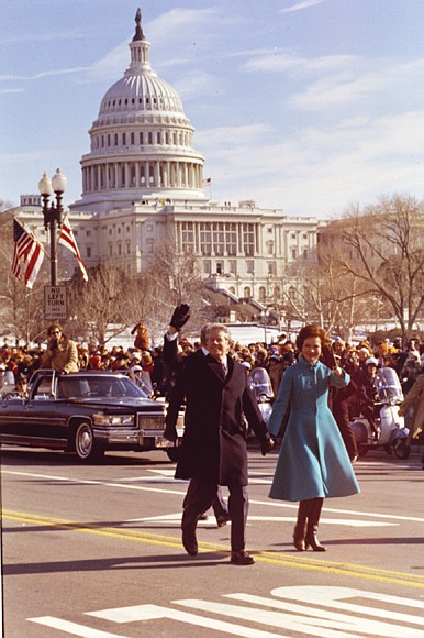 The Carters surprise onlookers, leaving their car and walking down Pennsylvania Avenue during the Inaugural Parade on Jan. 20, 1977.