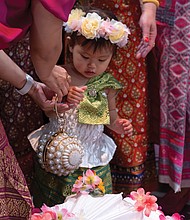 One-year-old dancer Anya Tangtrakul poses for a picture with other performers at the 26th Annual Asian American Festival at the Richmond Convention Center on May 4.