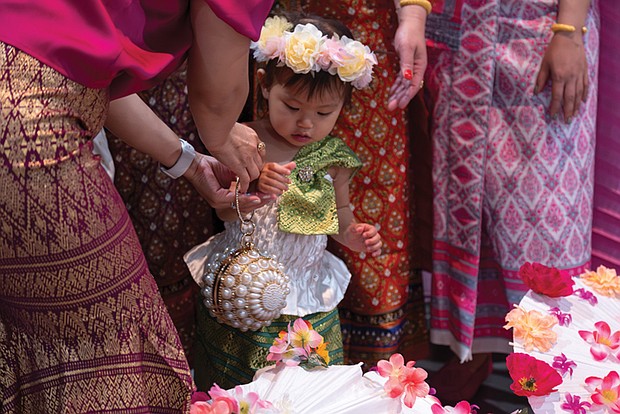 One-year-old dancer Anya Tangtrakul poses for a picture with other performers at the 26th Annual Asian American Festival at the Richmond Convention Center on May 4.