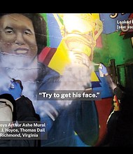 Screen grab from Unicorn Riot Youtube video of Patriot Front members Nathan Noyce & Thomas Dail destroying Arthur Ashe mural in Battery Park in October 2021.
