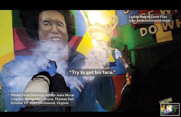 Screen grab from Unicorn Riot Youtube video of Patriot Front members Nathan Noyce & Thomas Dail destroying Arthur Ashe mural in Battery Park in October 2021.