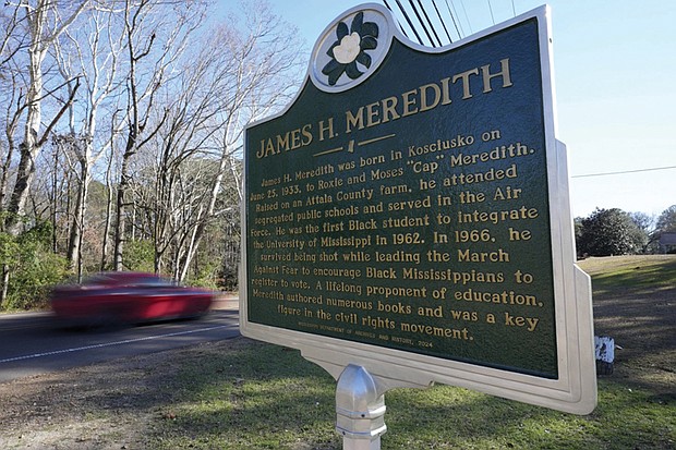 A car speeds past a Mississippi Department of Archives and History marker recognizing the legacy of James Meredith in the Civil Rights Movement in Kosciusko, Miss.