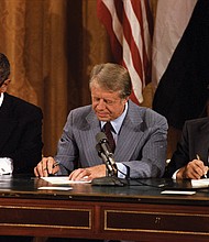 The Camp David summit ended on Sept. 17, 1978. In this photo Egypt President Anwar Sadat, U.S. President Jimmy Carter, and Israel Prime Minister Menachem Begin sign an agreement in the East Room of the White House, thus creating a framework for peace in the Middle East.