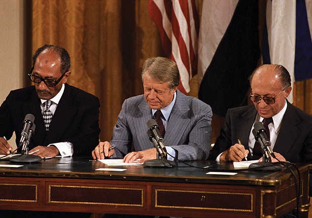 The Camp David summit ended on Sept. 17, 1978. In this photo Egypt President Anwar Sadat, U.S. President Jimmy Carter, and Israel Prime Minister Menachem Begin sign an agreement in the East Room of the White House, thus creating a framework for peace in the Middle East.