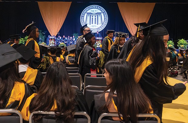 More than 100 Virginia Commonwealth University graduates walk out as Gov. Glenn Youngkin delivers his commencement address at the Greater Richmond Convention Center.