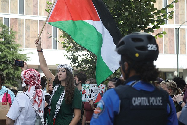 Sereen Haddad, a Virginia Commonwealth University junior, leads a student-organized walkout of at least 100 demonstrators on Oct. 7, 2024, marking the one-year anniversary of Israel’s war against Hamas in Gaza. The walkout, from Monroe Park Campus to the Virginia General Assembly Building, called for action from Virginia lawmakers and VCU leaders.