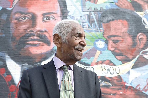 Richard Waller Jr., 86, of Waller & Co. Jewelers stands in front of a mural that tells the story of his 124-year-old jewelry business, located near the corner of Broad and 1st at 19 E. Broad St.