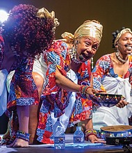 Janine Bell, founder and artistic director of Elegba Folklore Society, on Dec. 28 pours libation and performs during the 58th Capital City Kwanzaa celebration. The theme for the event was “Knowledge of Self.”