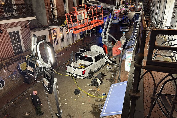 The suspect's pickup truck crashed near the Royal Sonesta New Orleans hotel, photos show. CNN has blurred parts of the image.
Mandatory Credit:	Paul S. via CNN Newsource