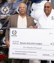 Judson W. Robinson III, left, the Houston Area Urban League’s president & CEO, receives
$500,000 grant from Harris County Commissioner Rodney Ellis to expand services at its Housing Preservation Center. Photo by Ivonne Godinez, Office of Harris County Commissioner Rodney Ellis