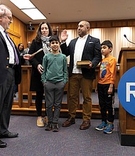 Ali Faruk is sworn in as a new School Board member representing the 3rd District at City Hall on Wednesday, Jan. 8. He is joined by his wife, Samieh, and their two sons, Yusef and Zayn.
Faruk is one of five new members on the board, along with four returning members.