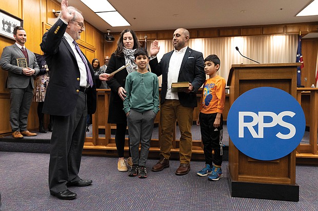 Ali Faruk is sworn in as a new School Board member representing the 3rd District at City Hall on Wednesday, Jan. 8. He is joined by his wife, Samieh, and their two sons, Yusef and Zayn.
Faruk is one of five new members on the board, along with four returning members.