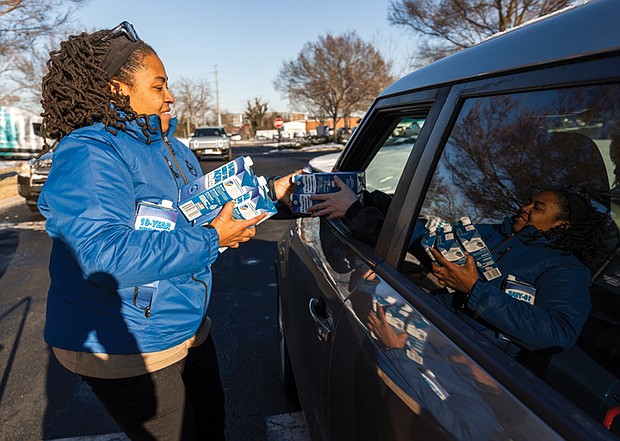 Priscilla Wright with the Richmond Parks and Recreation Department distributes water to cars at Midtown Green on West Leigh Street on Jan. 7. City of Richmond Human Services partnered with the Richmond Sheriff’s Office and the American Red Cross to provide bottled water in high-priority areas.
