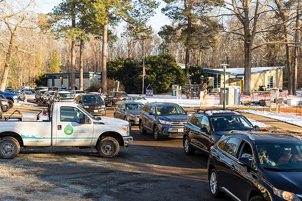Cars were turned away from Pine Camp Community Center on Old Brook Road after the water supply ran out. The site was one of 11 set up after a boil water advisory was issued following a winter storm-related outage. A truck soon delivered more water and a new line formed.