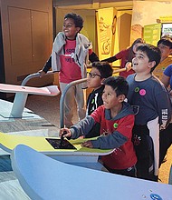 Children interact with the “MathAlive!” exhibition at the Science Museum of Virginia, where they explore the connections between math and everyday life through activities. The exhibition, open until Jan. 12, features over 30 interactive stations.