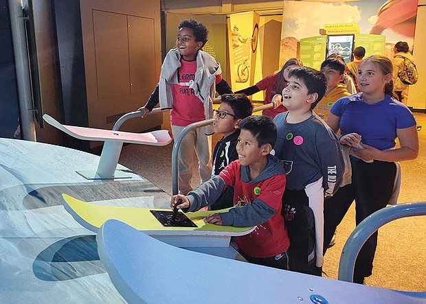 Children interact with the “MathAlive!” exhibition at the Science Museum of Virginia, where they explore the connections between math and everyday life through activities. The exhibition, open until Jan. 12, features over 30 interactive stations.