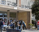 Families line up outside Carver Elementary School on Thursday, Jan. 9, to receive lunch and bottled water as part of Richmond Public Schools' effort to support the community during the ongoing water crisis.  Julianne Tripp Hillian/Richmond Free Press