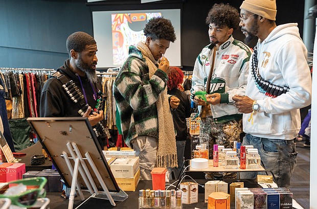 Shoppers browse as Abdul Haqq (left), of Haqq’s Drawer and Kenneth Billups
(right), of Potential Royal Nation, speak with customers.