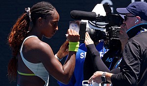 Coco Gauff writes a message on a TV camera in support of those impacted by the wildfires in Los Angeles.
Mandatory Credit:	Edgar Su/Reuters via CNN Newsource