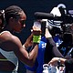 Coco Gauff writes a message on a TV camera in support of those impacted by the wildfires in Los Angeles.
Mandatory Credit:	Edgar Su/Reuters via CNN Newsource