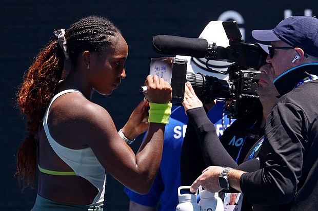Coco Gauff writes a message on a TV camera in support of those impacted by the wildfires in Los Angeles.
Mandatory Credit:	Edgar Su/Reuters via CNN Newsource