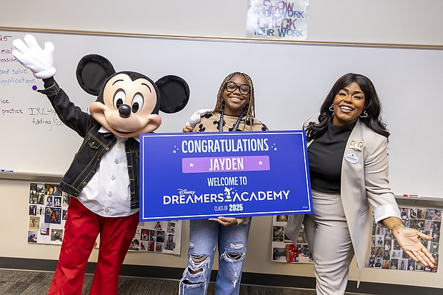 Mickey Mouse and Walt Disney World Ambassador Shannon-Smith Conrad pose with Alief Taylor High School (Houston, TX) student Jayden Kelly moments after she was surprised on January 13, 2025, with the news that she is one of 100 students selected for this year’s Disney Dreamers Academy at Walt Disney World Resort in Florida in March. Disney Dreamers Academy, in its 18th year, is an educational mentorship program that is fostering the career dreams of high school students from varying backgrounds and communities nationwide. (Christian Thompson)