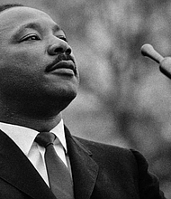 Dr. Martin Luther King Jr. speaks before a crowd of 25,000 civil rights marchers outside the state capitol building on March 25, 1965, in Montgomery, Alabama. Stephen F. Somerstein/Getty Images