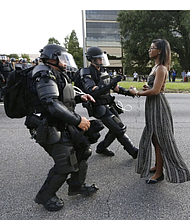 Activist Ieshia Evans stands her ground while offering her hands for arrest during a protest against police brutality outside the Baton Rouge Police Department in Louisiana on July 9, 2016. Evans, a 28-year-old Pennsylvania nurse and mother of one, had traveled to Baton Rouge to protest. Jonathan Bachman/Reuters