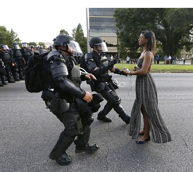Activist Ieshia Evans stands her ground while offering her hands for arrest during a protest against police brutality outside the Baton Rouge Police Department in Louisiana on July 9, 2016. Evans, a 28-year-old Pennsylvania nurse and mother of one, had traveled to Baton Rouge to protest. Jonathan Bachman/Reuters