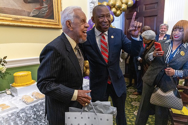 Delegate Don Scott, speaker of the Virginia House of Delegates, presents a birthday gift to former Gov. L. Douglas Wilder during the General Assembly’s recognition of the 40th anniversary of his historic election as Virginia’s first African American lieutenant governor. The
presentation took place in the House of Delegates and Senate chambers Friday, Jan. 17, coinciding with Wilder’s 94th birthday.