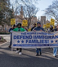 Protesters march in Monroe Park on Dr. Martin Luther King Jr. Day, carrying banners and chanting in solidarity with immigrant families during the “We Fight Back” protest, held in response to President Trump’s second inauguration and part of a nationwide call to action.