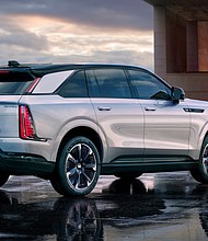 Rear 3/4 view of Cadillac ESCALADE IQ Sport in Flare Metallic.