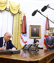 President Donald Trump signs a series of executive orders in the Oval Office of the White House on Thursday.
Mandatory Credit:	Anna Moneymaker/Getty Images via CNN Newsource