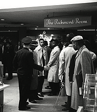 Richmond police attempt to move Virginia Union University students out of a restaurant in Thalhimers department store downtown where they refused to leave, protesting the white-only policy for service.