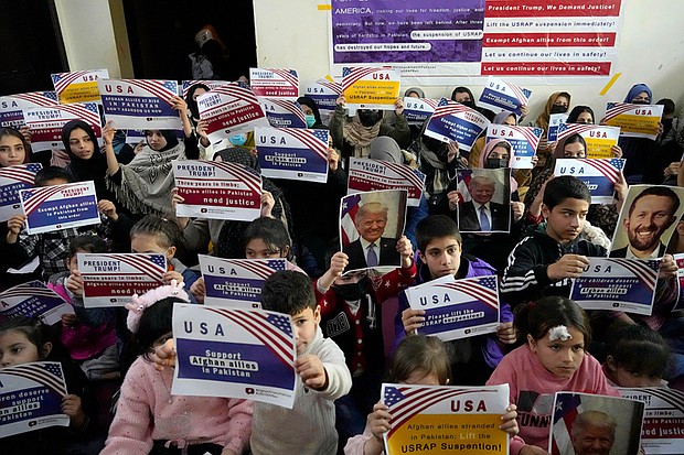 Afghan refugees hold placards during a meeting to discuss their situation after President Donald Trump paused U.S. refugee programs, in Islamabad, Pakistan, Friday, Jan. 24. When the U.S. pulled out of Afghanistan in August 2021, it carried tens of thousands of Afghans to safety. But years later, many others are still waiting to be resettled.