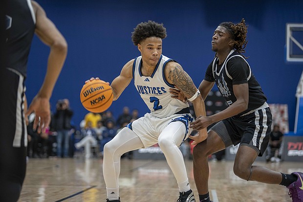 John Marshall’s Troy Henderson looks for an opening against Woodside’s defense during the Coaches 4 The Cure event at the Henrico Sports & Event Center on Saturday. The Justices edged Woodside 50-47 in the marquee matchup. Richmond Free Press/Julianne Tripp Hillian