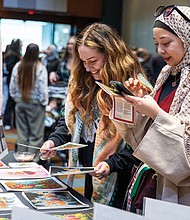 Richmond resident Zainab Tam (right) visits the TAOTAM (The Age of the Artist Movement) table during the 2nd Annual All About Palestine event on Saturday, Feb. 1, at the Greater Richmond Convention Center.