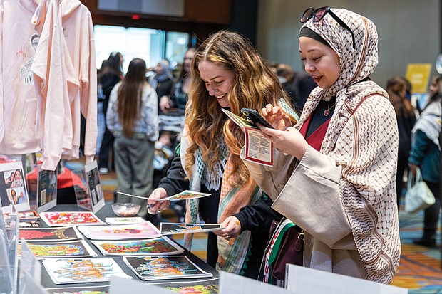 Richmond resident Zainab Tam (right) visits the TAOTAM (The Age of the Artist Movement) table during the 2nd Annual All About Palestine event on Saturday, Feb. 1, at the Greater Richmond Convention Center.